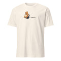 Between Sets Pixel Fitness Tee in Natural, with a seated capybara holding a cup on a kettlebell beside BETWEEN SETS lettering, front view