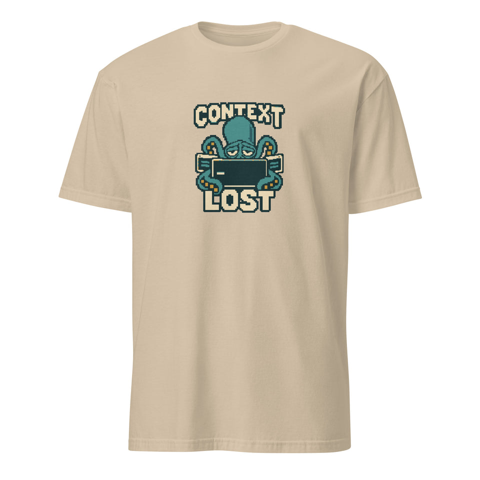 Context Lost pixel art developer t-shirt with a tired teal octopus behind an empty terminal and cream CONTEXT LOST lettering on a Sand unisex t-shirt, front view