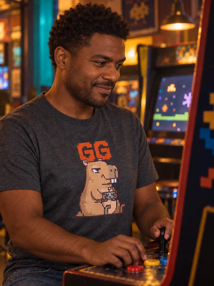 Man wearing an Unbothered GG tee while playing an arcade game